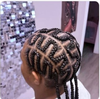 Intricate cornrow design on a child