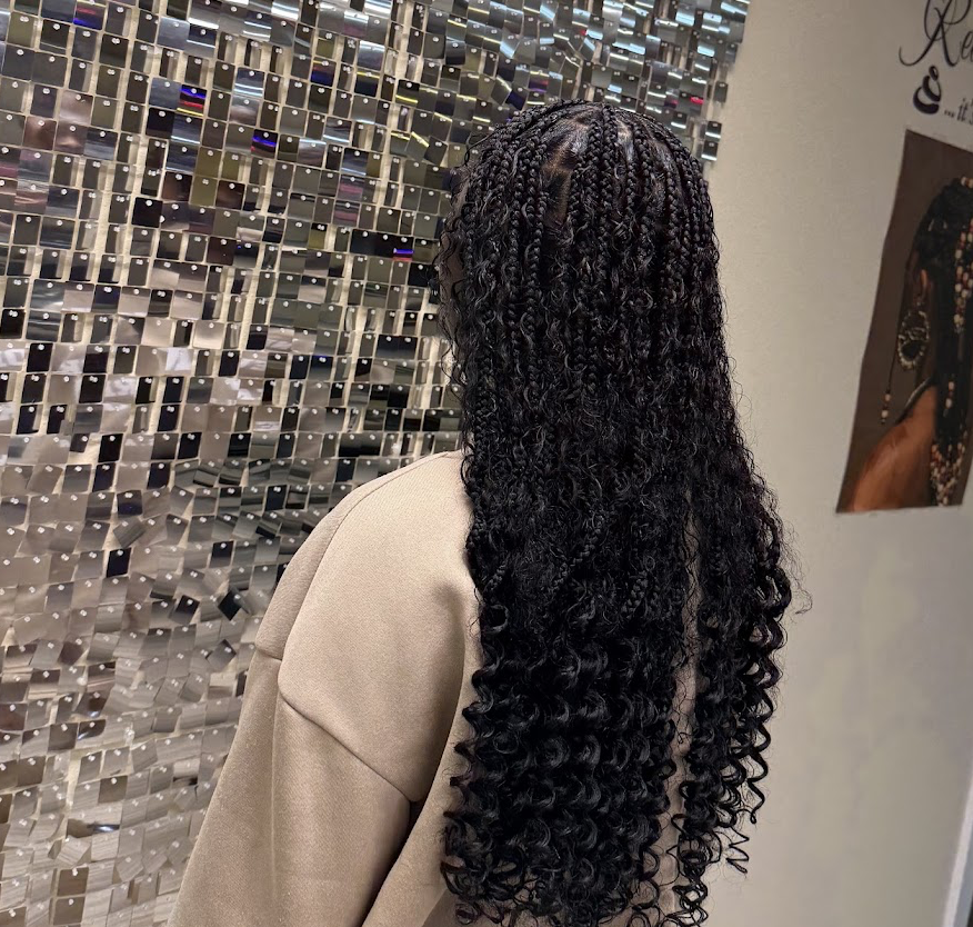Long knotless braids in front of the Signature Wall