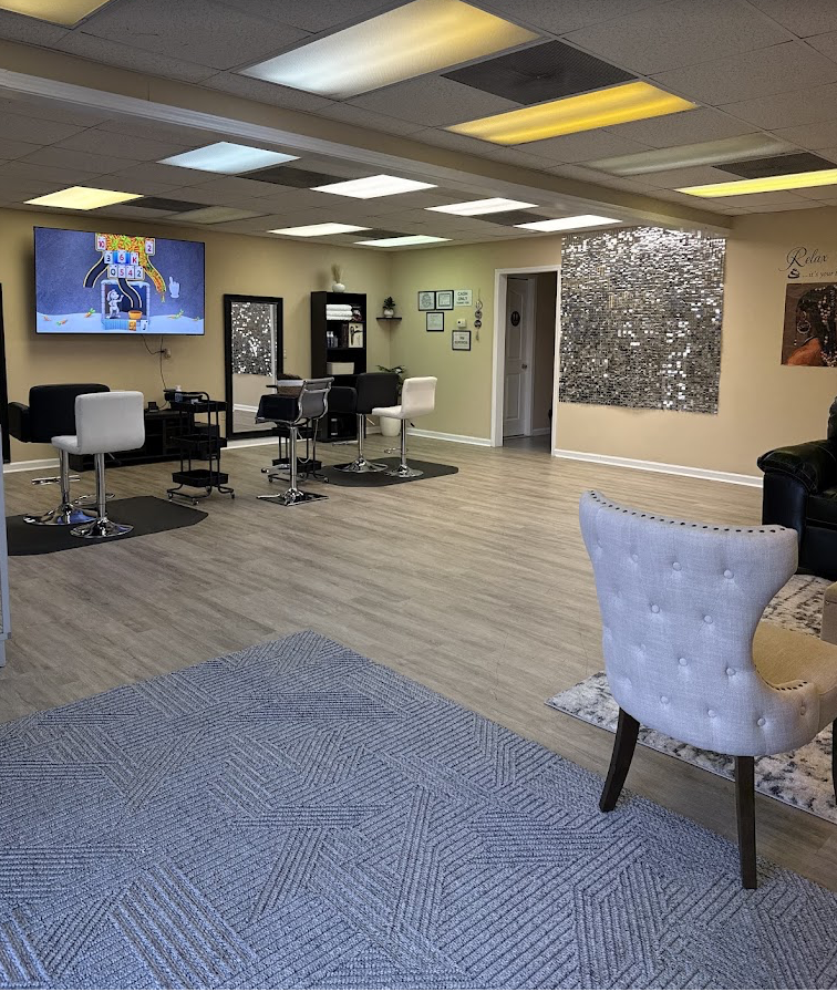Inside Unique African Hair Braiding Salon — styling stations and the Signature Wall
