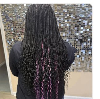 Boho braids in front of the Signature Wall